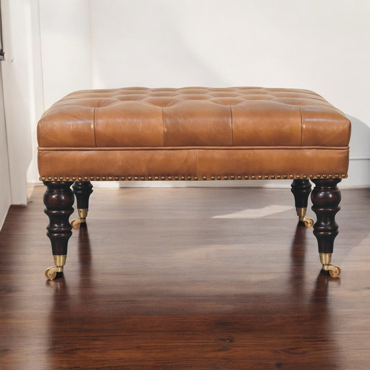 Sutton Buffalo Leather Studded Tan Ottoman with Castor Legs
