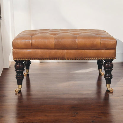 Sutton Buffalo Leather Studded Tan Ottoman with Castor Legs